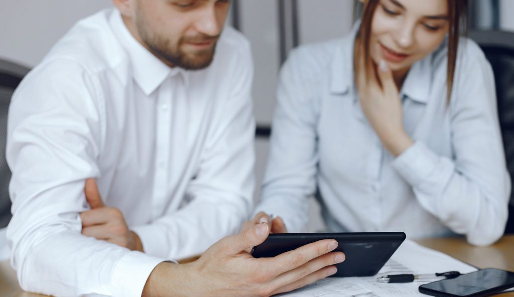 man with tablet business partners business meeting people sitting table scaled e1768904969657